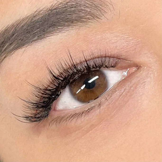 Close-up of wispy lash extensions on a brown eye