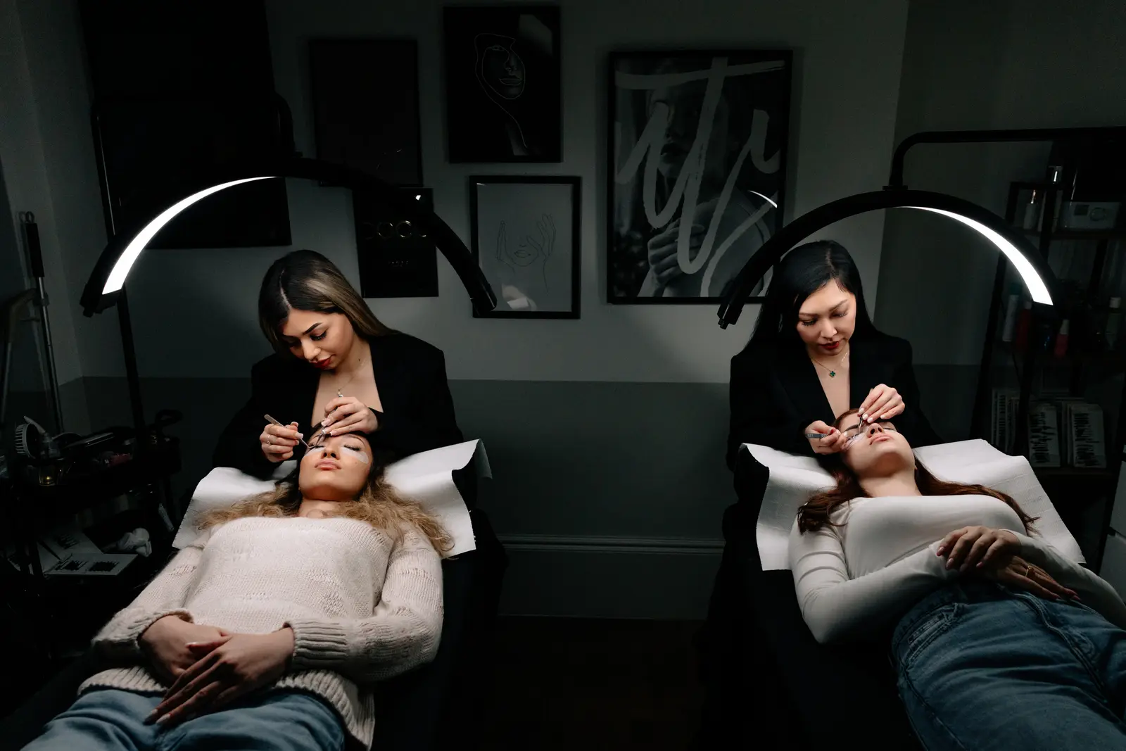 Two lash artists at work in the Envy Lashes London salon